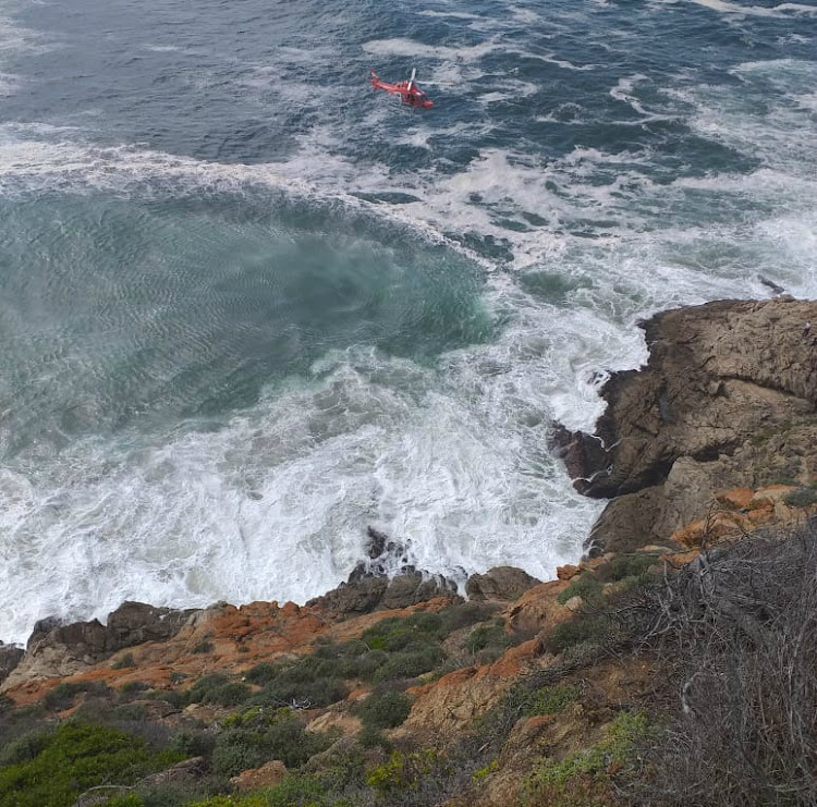 A helicopter helps retrieve the body of a man who drove off a cliff at Herolds Bay on the Garden Route on Wednesday.