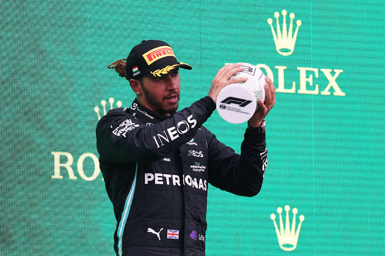 Third placed Lewis Hamilton celebrates on the podium during the F1 Grand Prix of Hungary at Hungaroring on August 01, 2021 in Budapest, Hungary.