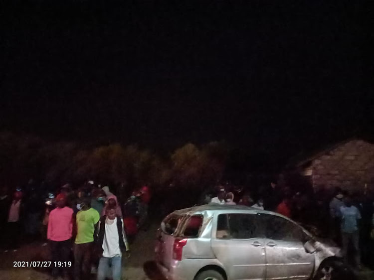 Members of the public mill around a scene of accident along Nairobi - Kangundo road at Nguluni in Matungulu, Machakos County on Tuesday, July 27