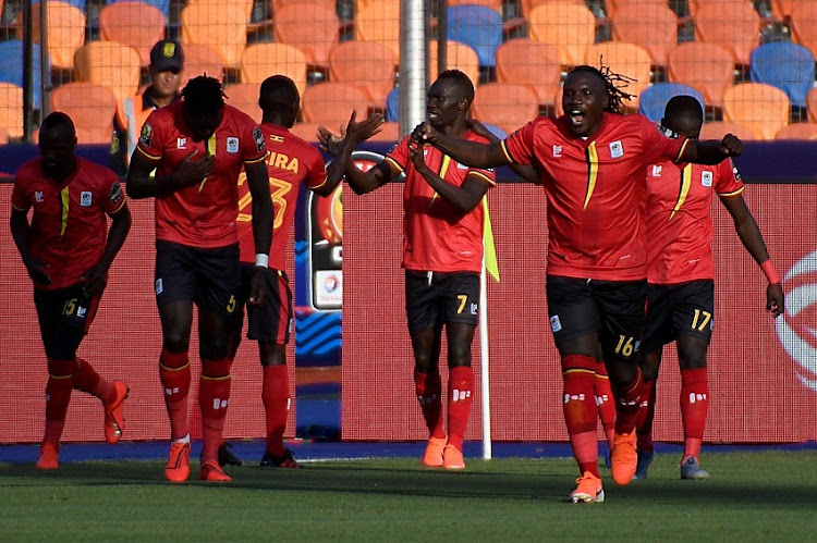 Uganda's forward Emmanuel Okwi (3rd-R) celebrates with his teammates after scoring a goal during the 2019 Africa Cup of Nations (CAN) football match between DR Congo and Uganda at Cairo International Stadium on June 22, 2019.