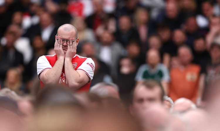 An Arsenal supporter shows their frustration during their Premier League draw against West Ham United at London Stadium on April 16 2023