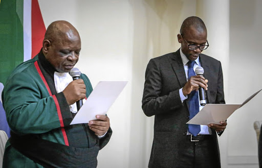 Deputy minister of finance David Masondo reads the oath of office during the swearing-in ceremony on Thursday.