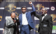 Boxer of the Year 2018 Thulani Mbenge accepting his award from then BSA chair, Pater Ngatane. On the left is former Gauteng sport and recreation MEC Faith Mazibuko.