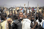 A striking miner leads a charge during the Marikana miners protest at Lonmin's mine near Rustenburg, North West.
