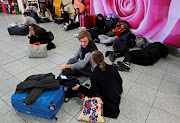 Passengers wait around in the South Terminal building at Gatwick airport after drones flying illegally over the airfield forced the closure of the airport, in Gatwick, Britain, on December 20 2018.