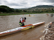 A canoeist washes his face as finishes the first day of the Dusi. 