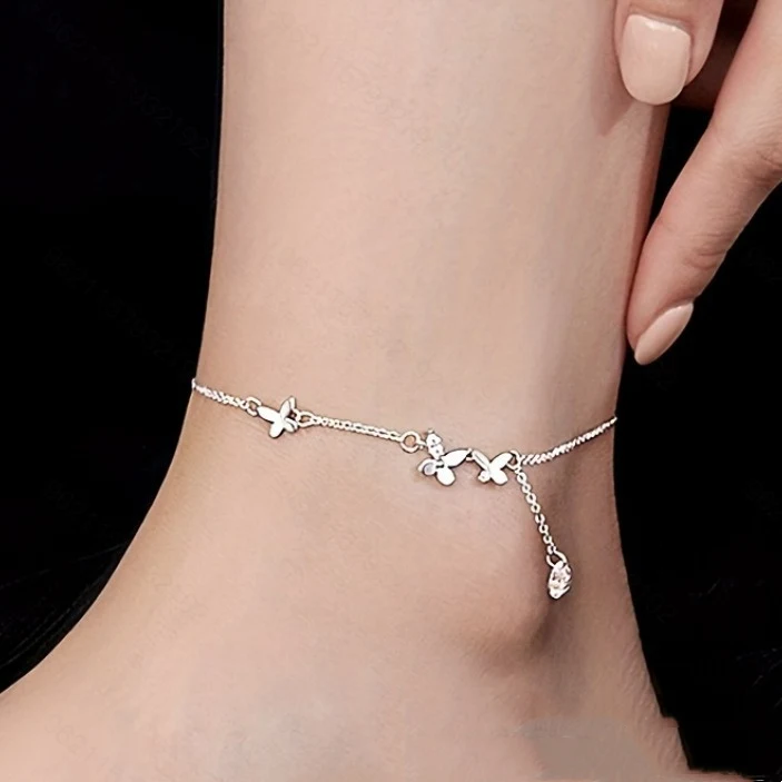 Tobillera de plata de ley S925 con mariposa, circonitas y borla de flores, perfecta para un look elegante y femenino en cualquier ocasión.