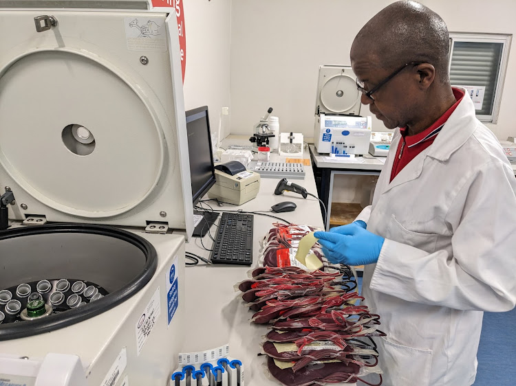 Cecil Sixoto checking blood units delivered by the Western Cape Blood Service to Groote Schuur Hospital blood bank