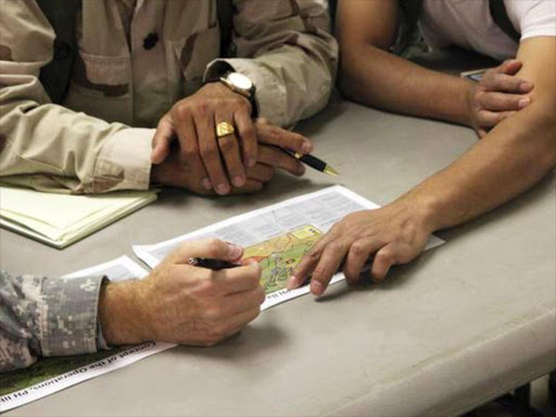 US Soldiers and the Afghan National Army unite during an operational meeting at Forward Operating Base Marjan at the National Training Center in Fort Irwin, California, US on August 20, 2011. /REUTERS