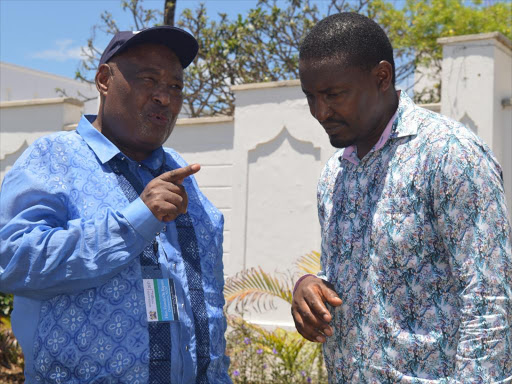 Former speaker Francis Ole Kaparo chats with Devolution CS Mwangi Kiunjuri at Pride inn hotel in Shanzu Mombasa yesterday./JOHN CHESOLI