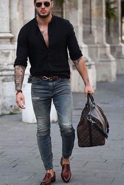 man wearing black shirt on jeans with bag and other fashion accessories