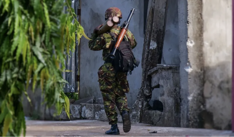 An armed soldier patrols the streets of Freetown following a series of attacks