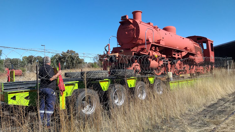 One of the three conventional engines is winched onto a lowbed in Bloemfontein for the journey to the eastern Free State.