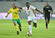 Zambia's Brian Mwila (R) shoves South Africa's Andile Jali off the during the International friendly match at Moruleng Stadium on June 13, 2017 Moruleng, South Africa.