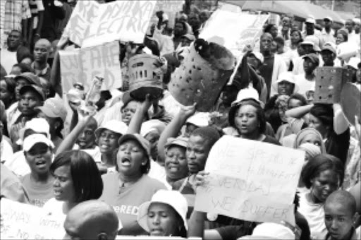 POWER TO THE PEOPLE: : Angry Solomondale residents are accusing the Polokwane municipality of failing to fulfill its promise to deliver services like electricity to the area. Pic. ELIJAR MUSHIANA. 25/01/2010.; © Sowetan. 25 JANUARY 2010 MONDAY: DEMAND: Angry Solomondale residents outside Polokwane in Limpopo are accusing the Polokwane Municipality for failing to fulfill the promise about service delivery water, roads and electricity, and removal of the ward councellor during the protest march to the Polokwane Municipality in Limpopo on Monday (yesterday). The chairperson of energy and head of infrustructure in Polokwane Municipality, Olga Mashakgomo said that the municipality has finalised the Solomondale problems and will be resolved soon PHOTO: ELIJAR MUSHIANA