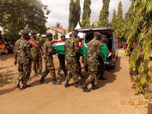 Kenya Defense Forces officers carry the body of their colleague killed in Somalia during his burial at Kwachocha in Malindi on Thursday. Photo Alphonce Gari