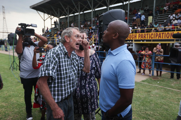 Irate parents argue as others gather for a meeting with Gauteng education MEC Penaza Lesufi on February 17 2022 at Hoerskool Jan Viljoen, Randfontein, West of Johannesburg. The event was rained out. Picture: Alaister Russell/The Sunday Times