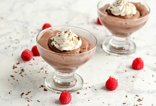 Heavenly chocolate mousse with whipped cream and chocolate shavings.
