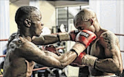 EAT LEATHER: Rofhiwa Maemu, left, and Tumelo Pedi exchange leather during their 
      
       clash 
      
      at the Turffontein Racecourse in Johannesburg 
      
      PHOTO: Nick Lourens