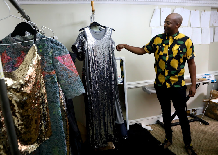 Fashion designer Thula Sindi with some of the outfits he will be showcasing at South African Fashion Week Spring/Summer 2023 at Mall of Africa.