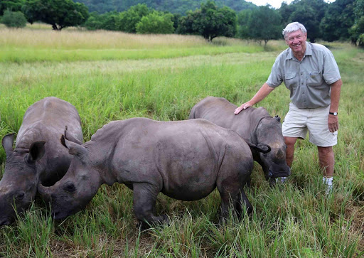 NEW HOPE: Australian Rhino Project founder Ray Dearlove interacts with orphaned South African rhino which he hopes to relocate ‘Down Under’ in an effort to try and save the species from being wiped out by poachers Picture: SUPPLIED