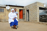 Andries Tatane's wife Rose Tatane with their son outside her new house that was donated. PHOTO: Mduduzi Ndzingi