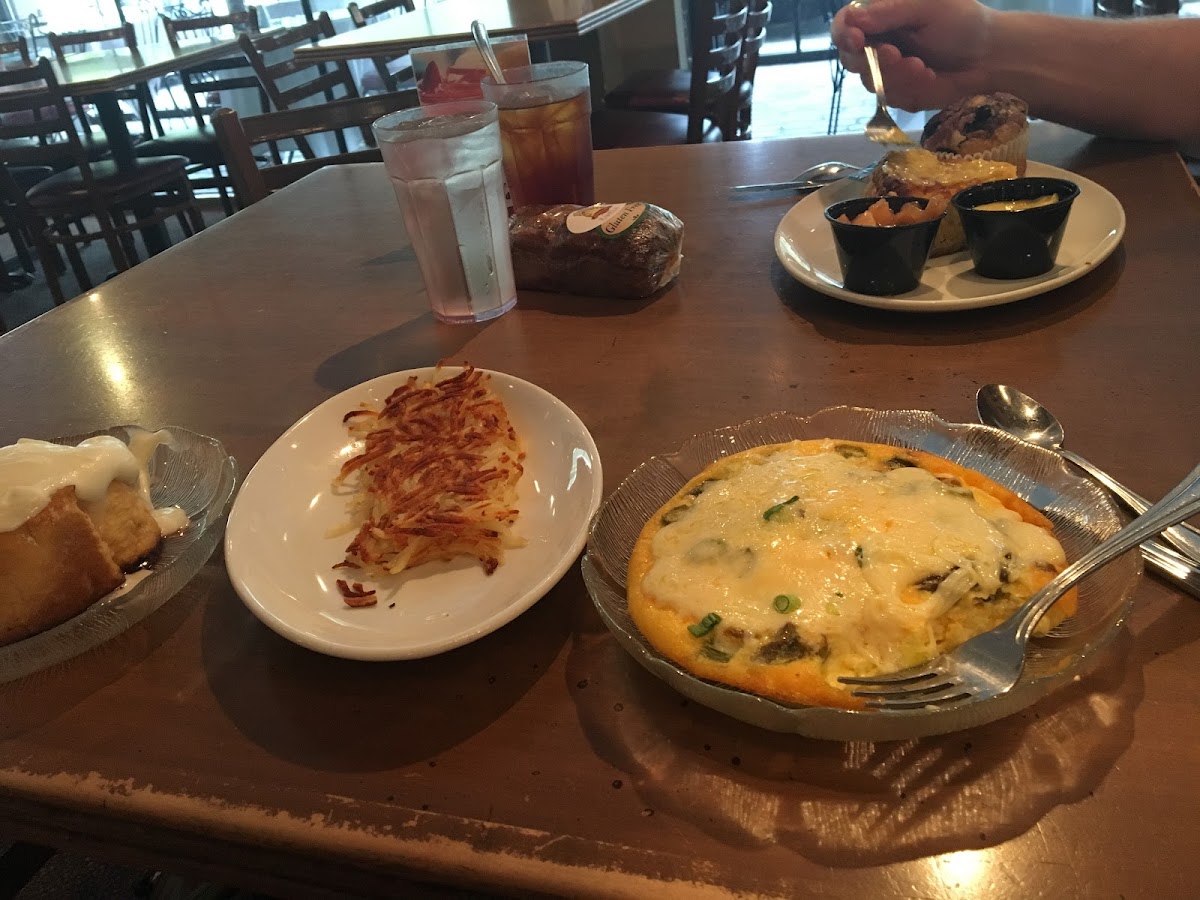 The three plates closest are gf... crustless quiche, hash browns, and a cinnamon roll... gf pumpkin bread is in center..