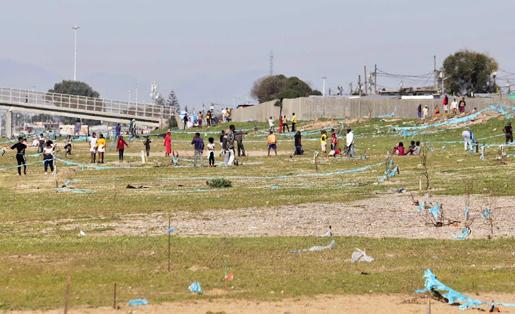 Backyarders from the Barcelona informal settlement in Nyanga, Cape Town, invade land next to the N2 on Thursday.