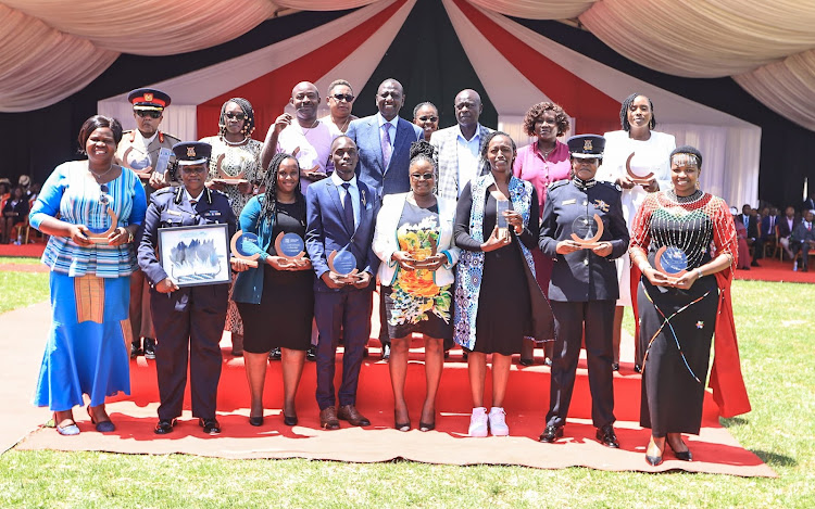 President William Ruto and his Deputy Rigathi Gachagua poses for a photo with the women and other individuals honored during the International Women's Day celebration in Embu on March 8, 2024.