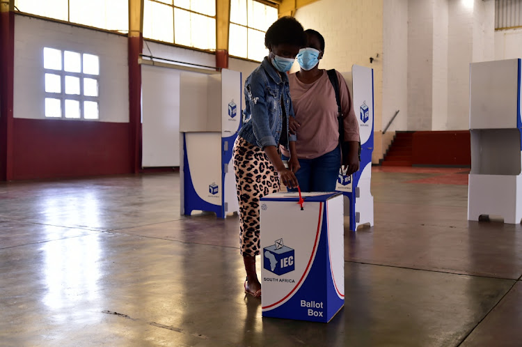 Lulama Maswana, 44, who is blind, casts her vote with the aid of her daughter, Yamkela, 19, at Kwazakhele High School