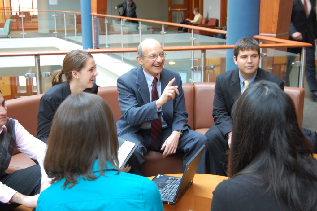 students and professor having a seated discussion