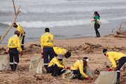 Members of  Working on Fire picking up litter along the Durban shore following heavy flooding   