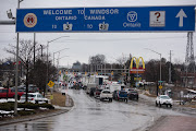 Protesters block access to the Ambassador Bridge during a demonstration in Windsor, Ontario, Canada, Friday, Feb. 11, 2022. The premier of Canada's biggest province declared a state of emergency, warning protesters who are blocking a key border crossing and causing gridlock in the Canadian capital that they face severe consequences if they don't leave. 