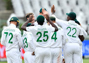 Duanne Olivier and his SA teammates celebrate the wicket of KL Rahul of India on day one of the third Test at Newlands in Cape Town on January 11 2022.