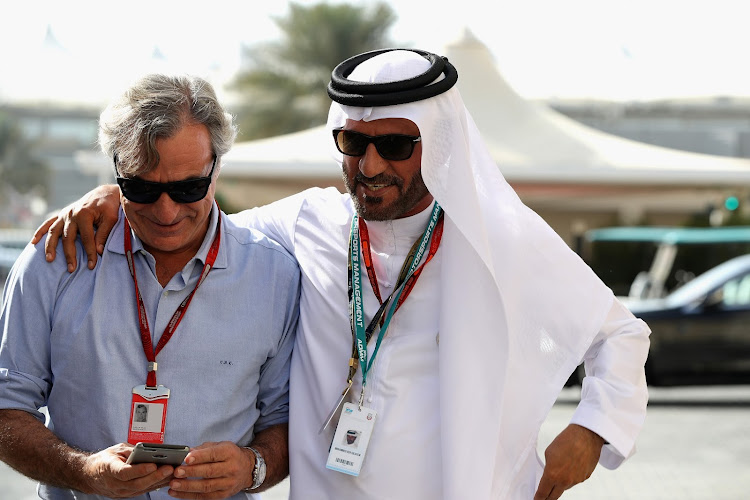 Carlos Sainz walks with Mohammed Ben Sulayem in the paddock before the Abu Dhabi Formula One Grand Prix at Yas Marina Circuit on November 27, 2016.