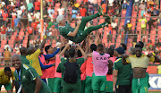 South African players celebrate victory and qualification with head coach Hugo Broos after their 2023 Africa Cup of Nations qualifier against Liberia at Samuel Kanyon Doe Sports Complex in Monrovia, Liberia, on March 28 2023.