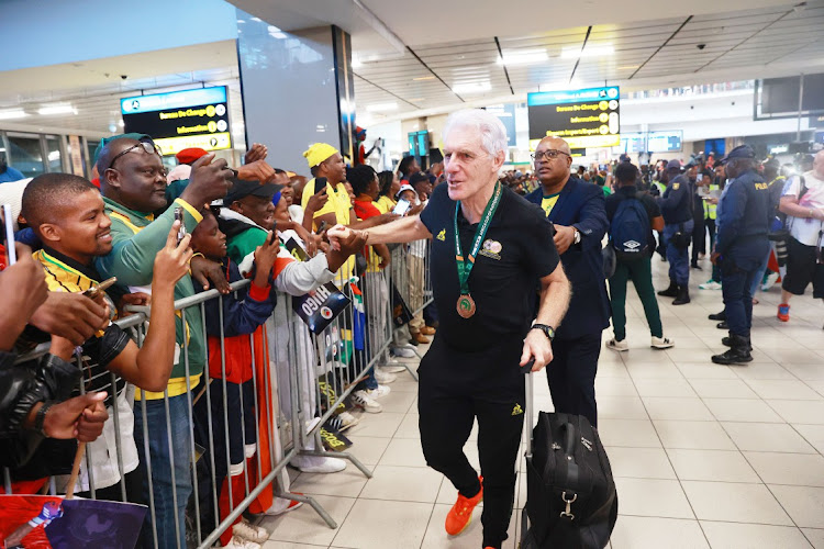 Bafana Bafana coach Hugo Broos during the national team's arrival at OR Tambo International Airport after winning the bronze medal at the Africa Cup of Nations.