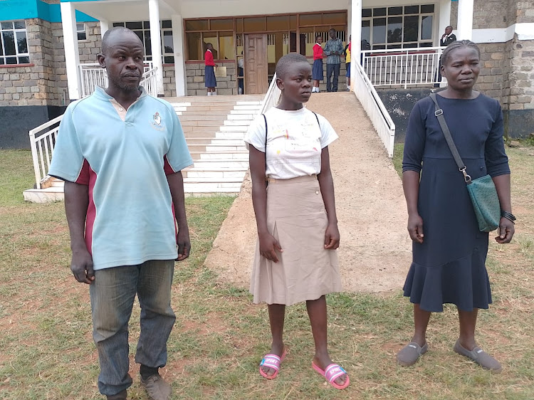 Gloria Adhiambo and her parents at Ng'iya Girls National School. The school's principal Hellen Juma sent a request to the Ministry of Education to have the girl transferred from Lenana School to Ng'iya. Image: JOSIAH ODANGA