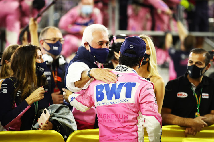 Race winner Sergio Perez of Mexico and Racing Point is congratulated by Lawrence Stroll after his maiden F1 victory in the F1 Grand Prix of Sakhir at Bahrain International Circuit on December 6 2020.