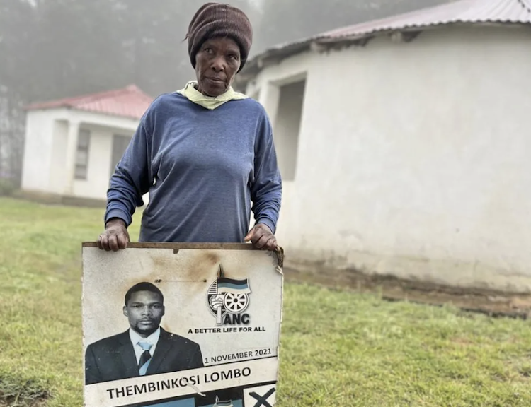 Lindeni Lombo stands with a poster of her murdered son