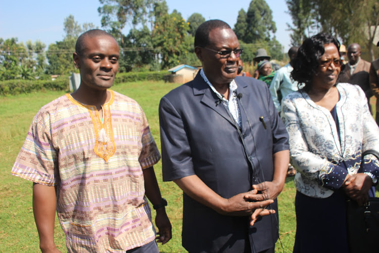 Jubilee Party candidate Chris Obure with his son and wife at Nyansakia priary school where he voted