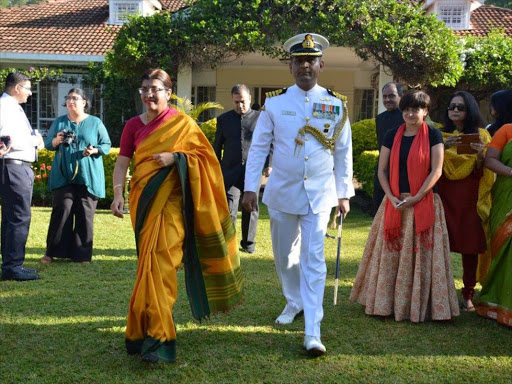 Indian High Commissioner Suchitra Durai walks to the podium with Captain M Mahesh