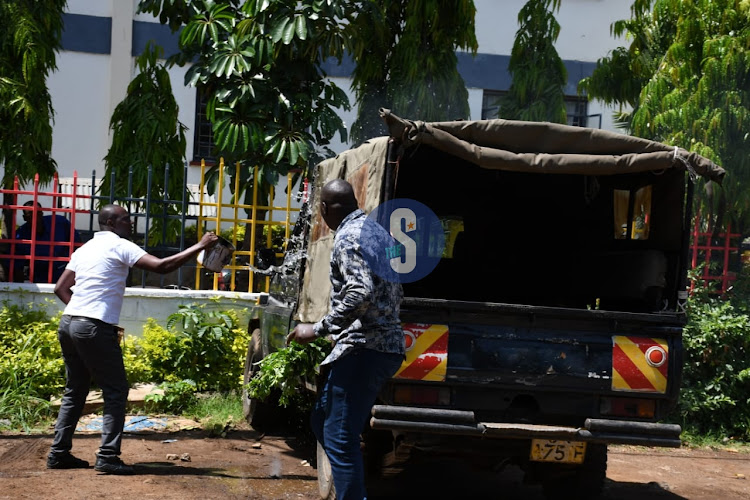 Police at Kisumu Central police station put off a fire set on one of the vehicles at the station on May 9, 2023.