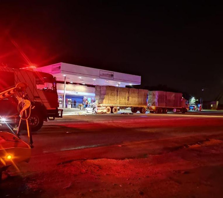 Three people, including a child, were killed when their vehicle crashed into the rear trailer of a truck at a petrol station near Fochville on Friday night.