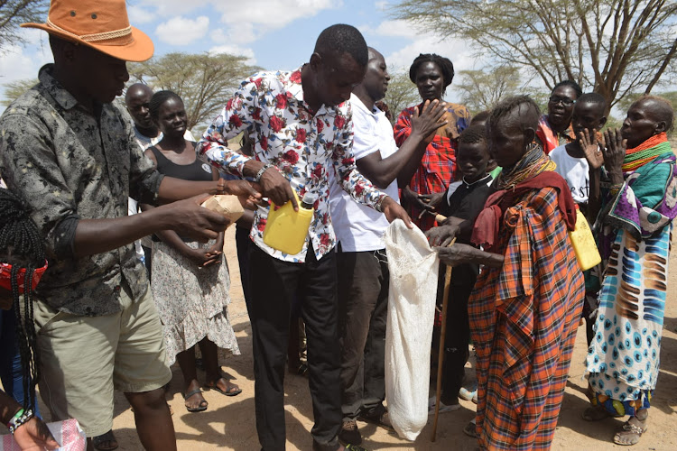 Apostle Daniel Wanyonyi and his crew distributions food items to the hunger-stricken families in Kakwanyang village Turkana Central