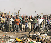 A crowd goes on the rampage in the Ramaphosa informal settlement, near Germiston, during the wave of  xenophobic  attacks in May 2008.