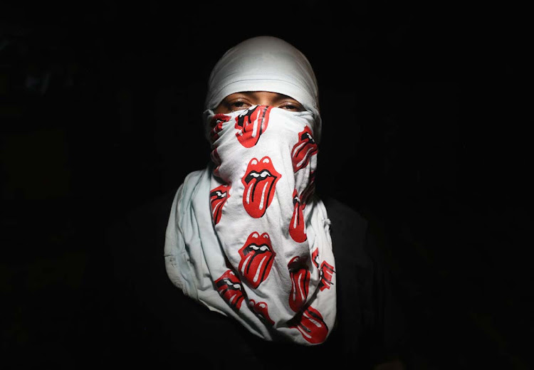 Street gang member 'Big Dog', 25, poses for a photo at his group's safe house on August 17, 2017 in San Pedro Sula, Honduras. His gang of more than 40 'sicarios' earns money by armed robbery and murder by hire. San Pedro Sula has one of the highest violence and homicide rates in the world for a populace not at war. Poverty and violence have driven immigration to the United States, although the number of US-bound immigrants has dropped during the first months of the Trump Presidency.