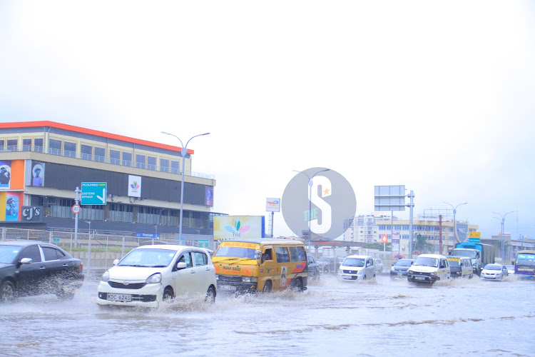 Vehicles struggle through the flooded rain waters at Imara Daima stage along Mombasa Road , Nairobi on December 14, 2023