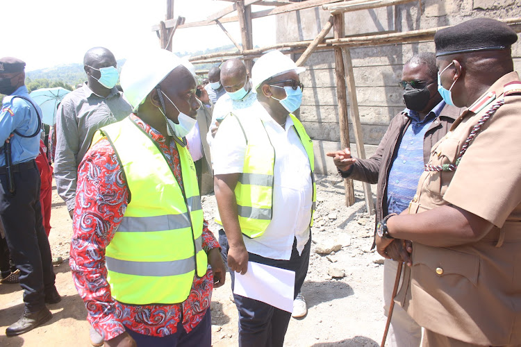 Housing and Urban Development PS Charles Hinga (C) when he inspected Nyansiongo market