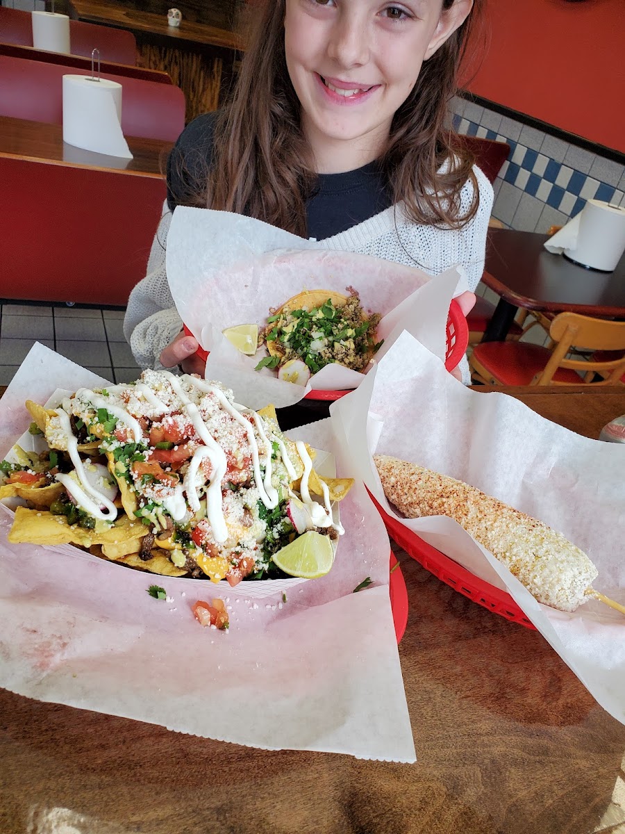 Supreme Nachos, street corn, chicken taco